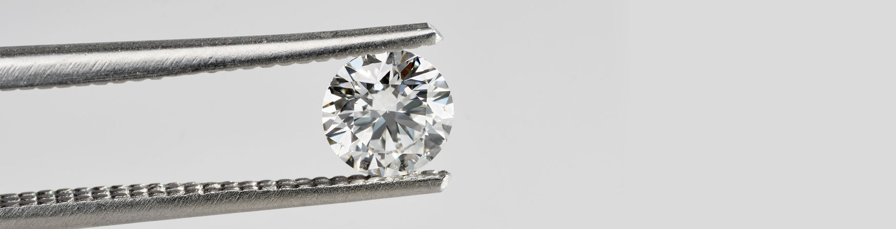 a diamond held in tweezers
